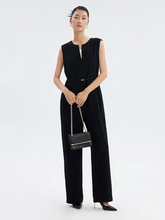 a lady wears a black full length triacetate sleeveless jumpsuit